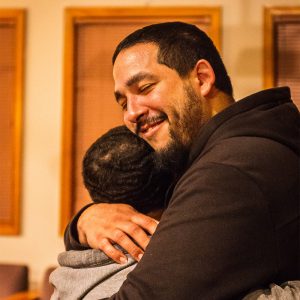 Hector hugs his child