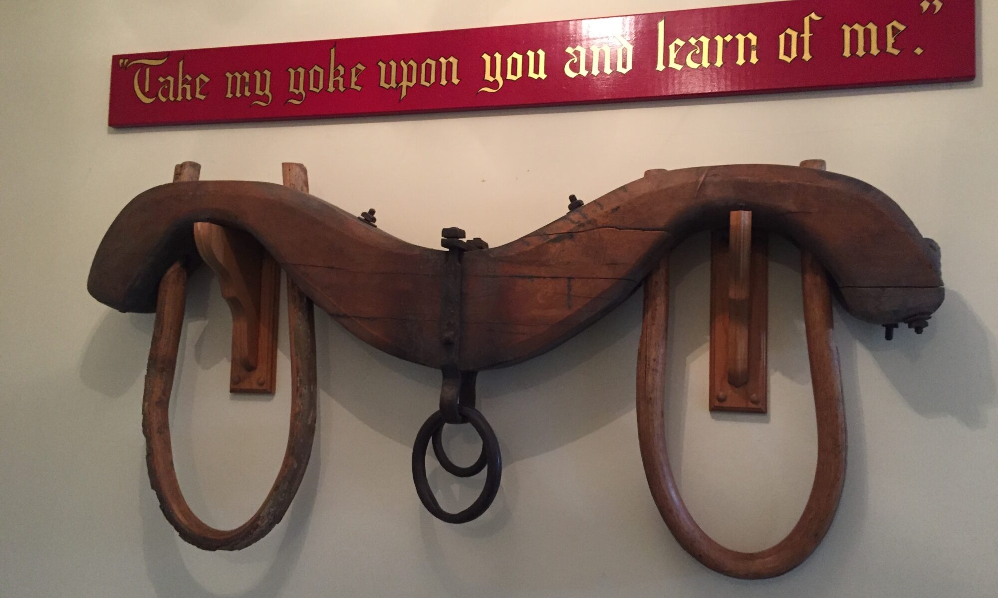 A yoke with the words "Take my yoke upon you and learn of me" written above it.