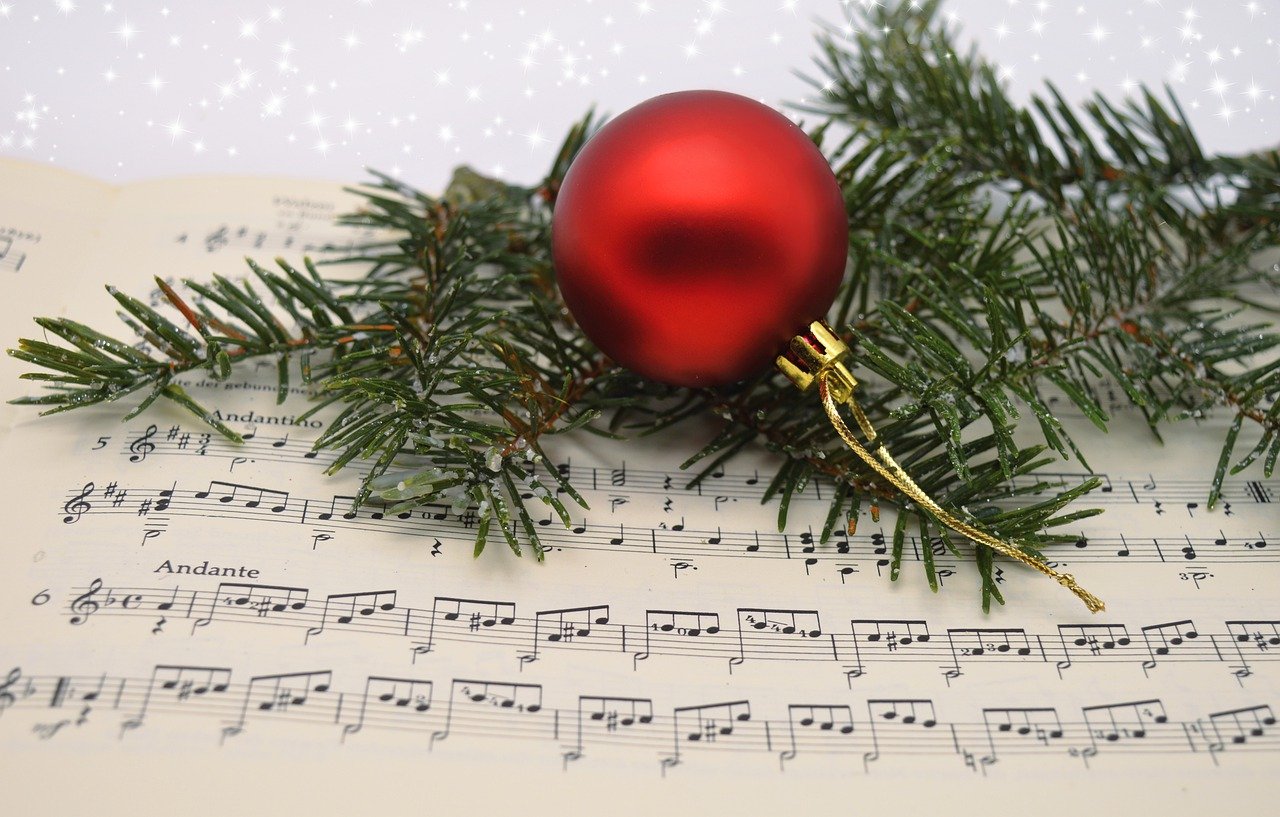 Sheet music with an ornament and greens