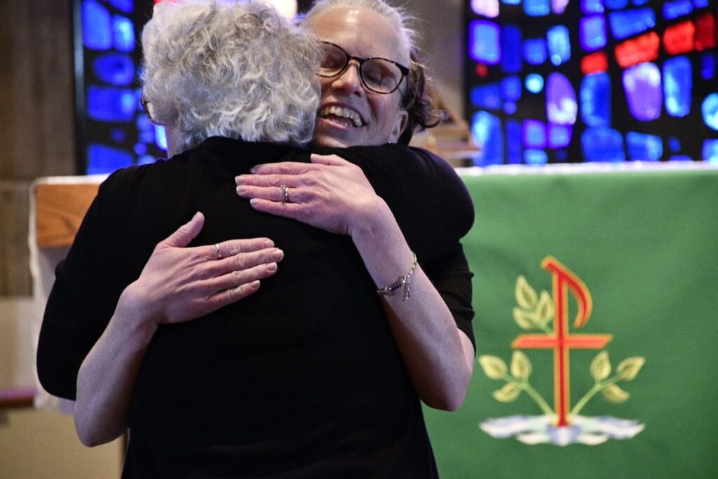 Call Committee Chair Francine Passerini embraces the Rev. Kelley Ketcham, new pastor of St. Mark's.