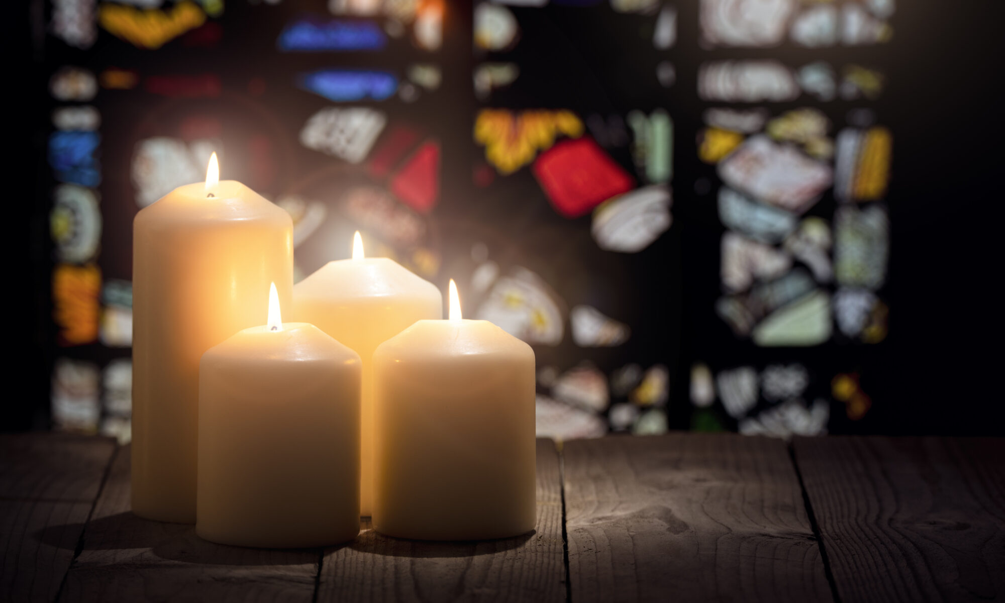 An image with candles and stained glass
