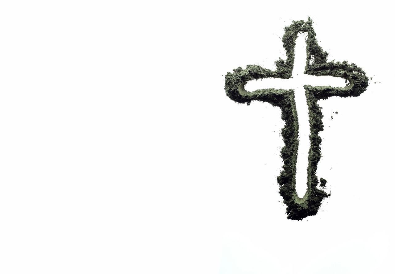 A stylized cross, drawn with ashes